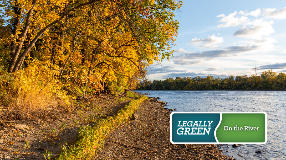 text legally green on the river over n image of the Mississippi River and turning fall foliage