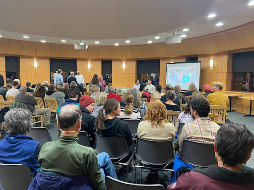 a crowd at a panel discussion