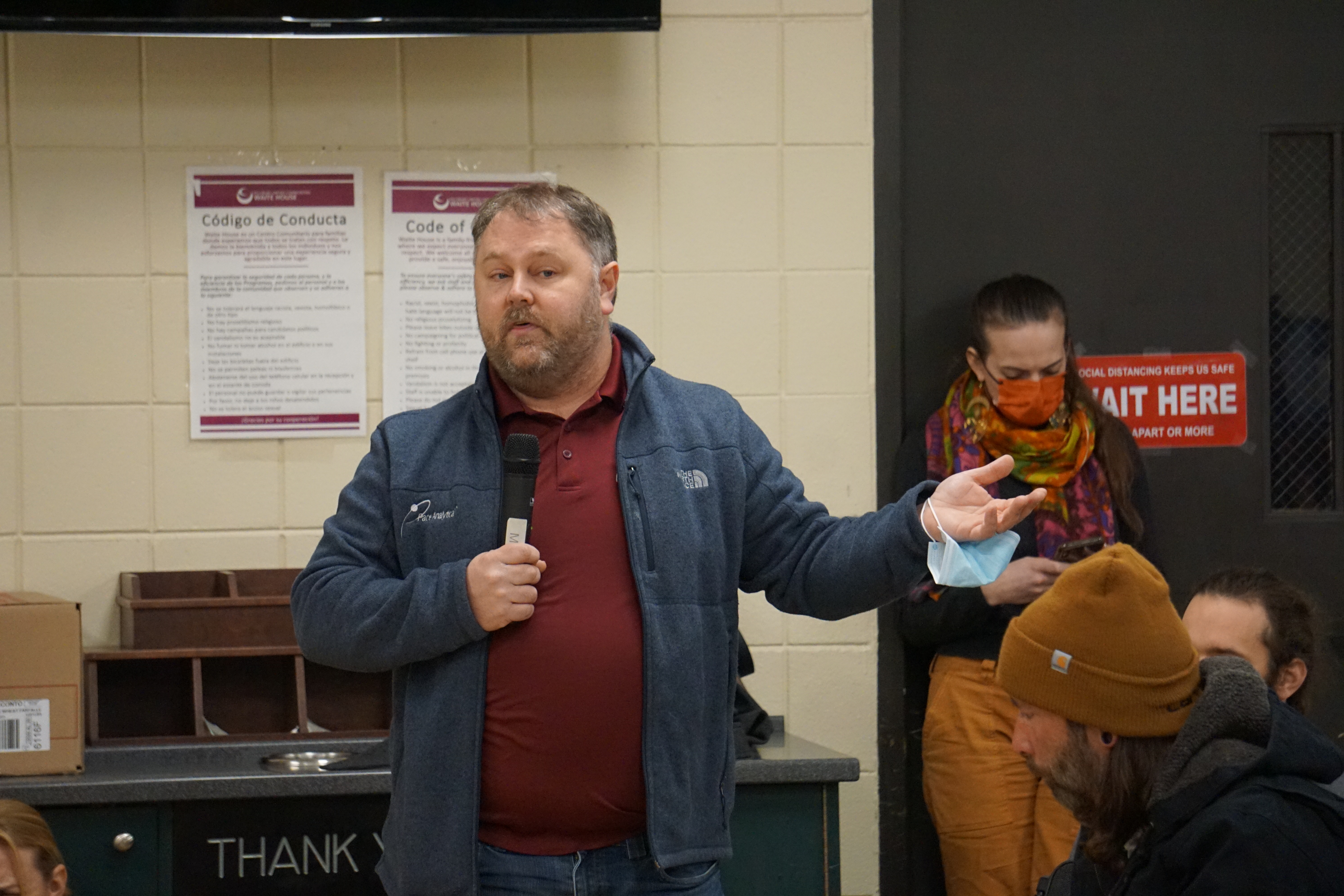 a parent speaks to the crowd