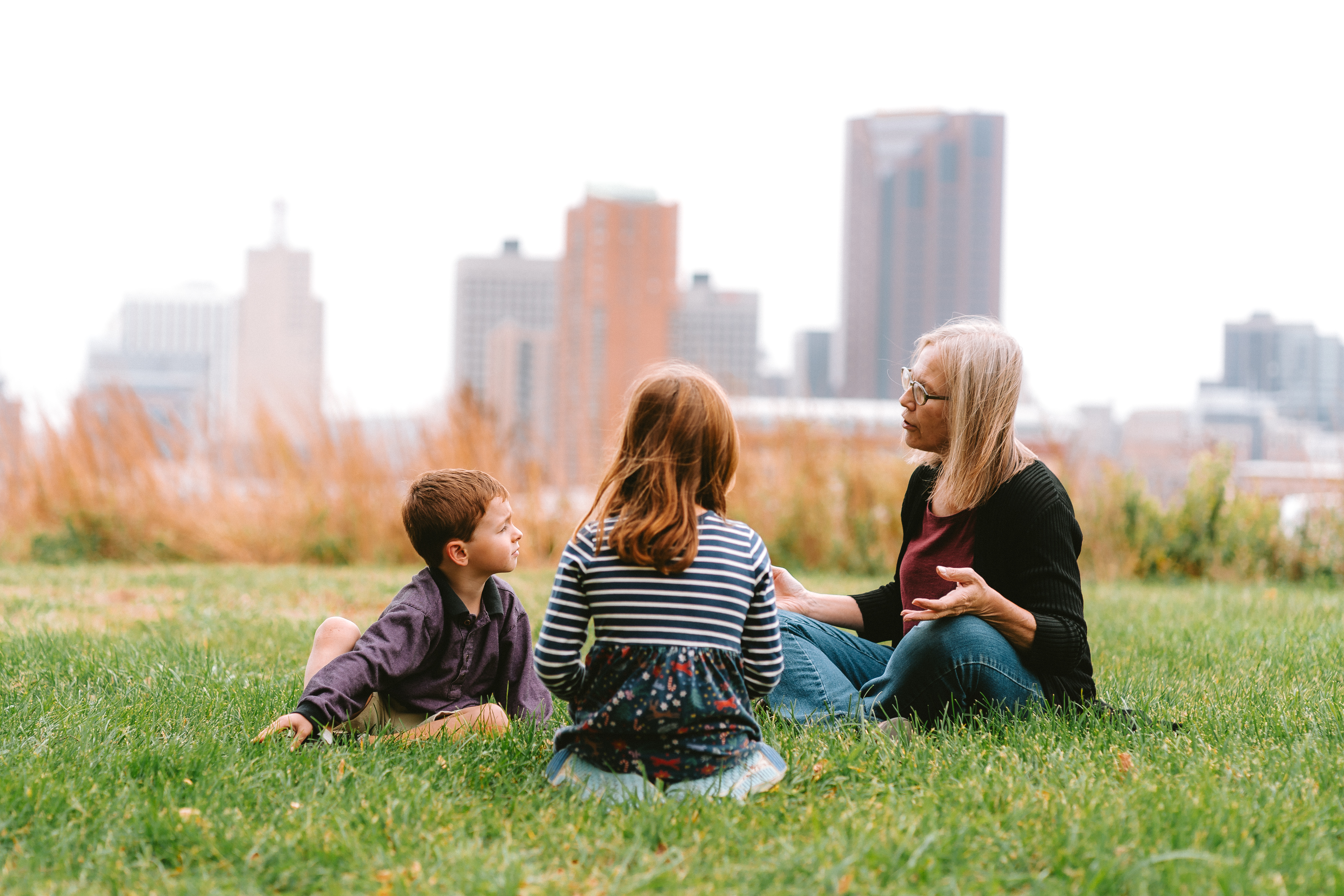 MCEA Climate Attorney, Barb Freese, talks with her grandchilden in front of the St. Paul city skyline. Barb says her work is motivated by her desire to protect people in St. Paul and across the world from the worst impacts of climate change