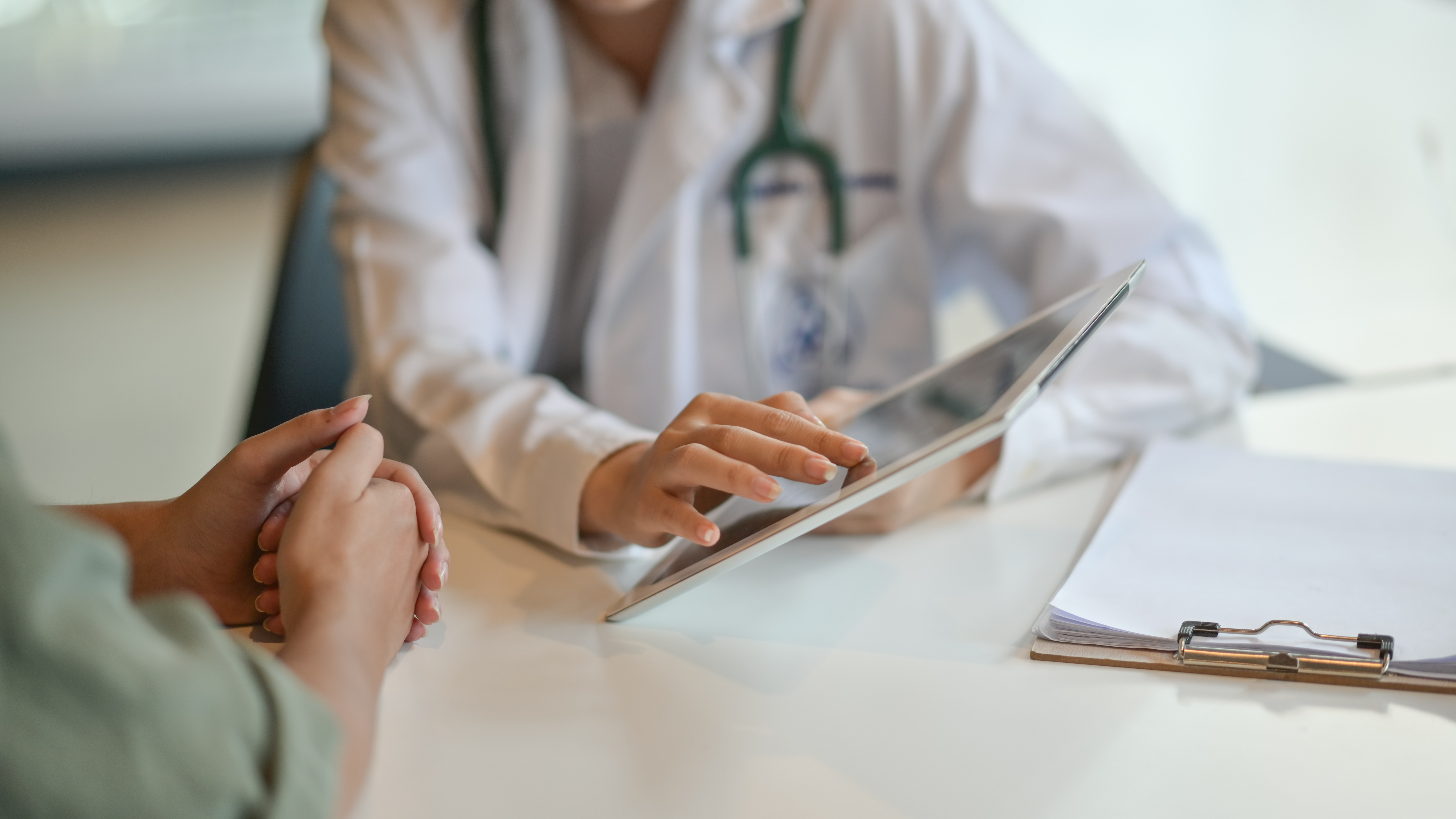 image of a doctor showing a chart to a patient