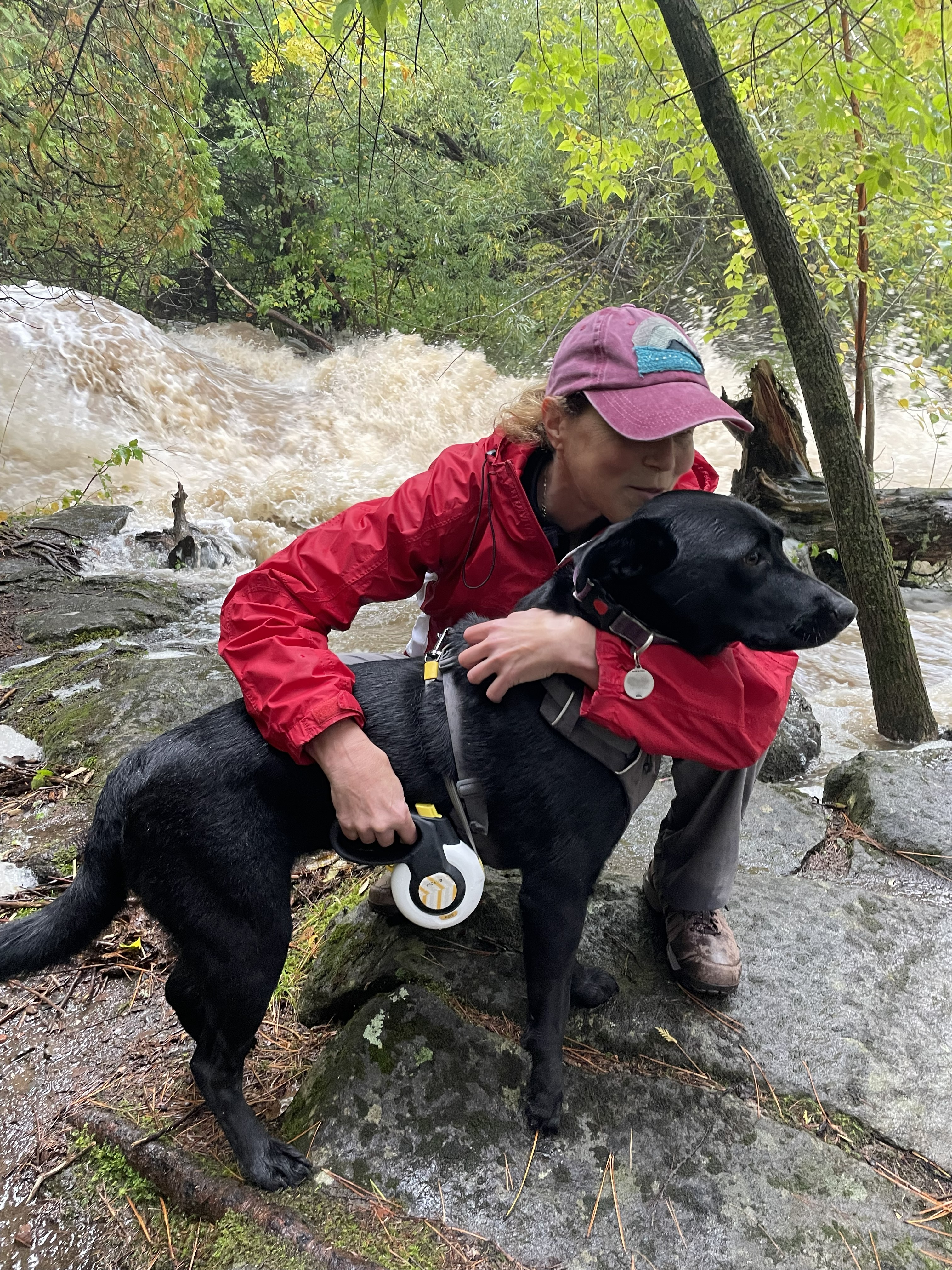 Libby Bent and her dog near her beloved Tischer Creek, which flows into Lake Superior
