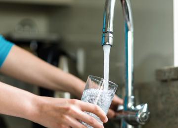 a hand getting tap water