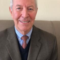 a photo of a smiling white man in a tie