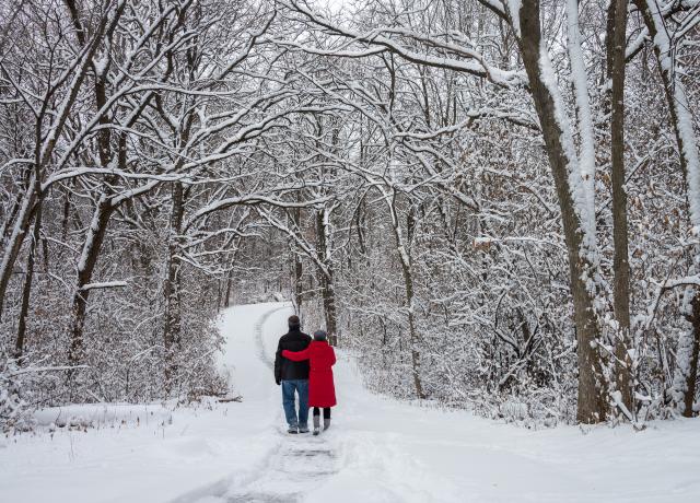two people walking in snow