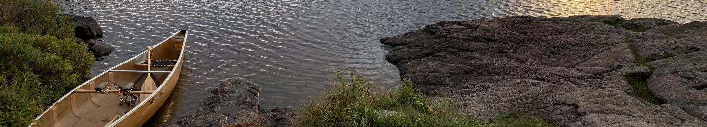 A canoe on a lake shore in the boundary waters