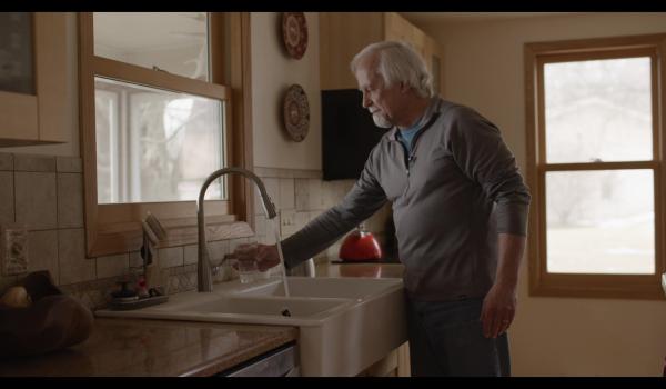 Paul getting water from his sink