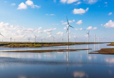 wind turbine with water in foreground