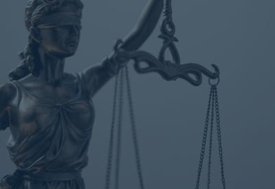 blue overlay on top of "justice" a blindfolded woman holding scales