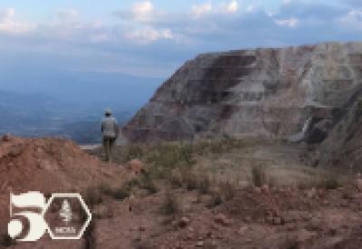 a man in honduras standing in a roacky landscape