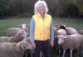 Beth Slocum stands with some of her sheep at her small sheep farm in Vasa, Minn