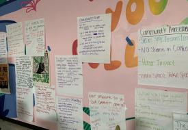 pink wall with notes on it with people's thoughts about cumulative impacts written on them