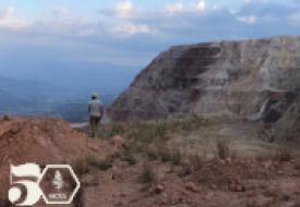 a man in honduras standing in a roacky landscape