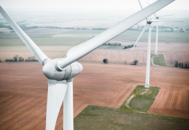 two wind turbines in a field