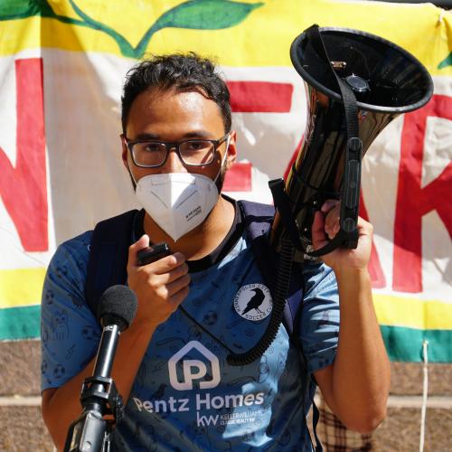 joe vital holding a megaphone at a rally