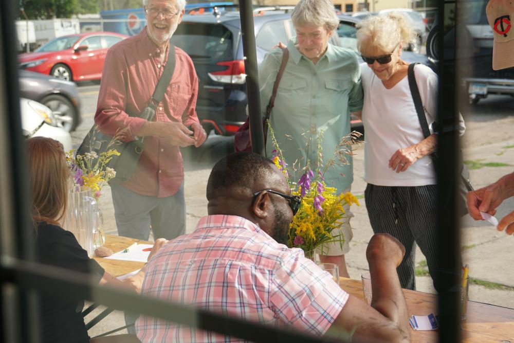 Photo of people at the check-in table of the Duluth event