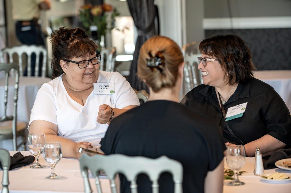 photo of three people at a table