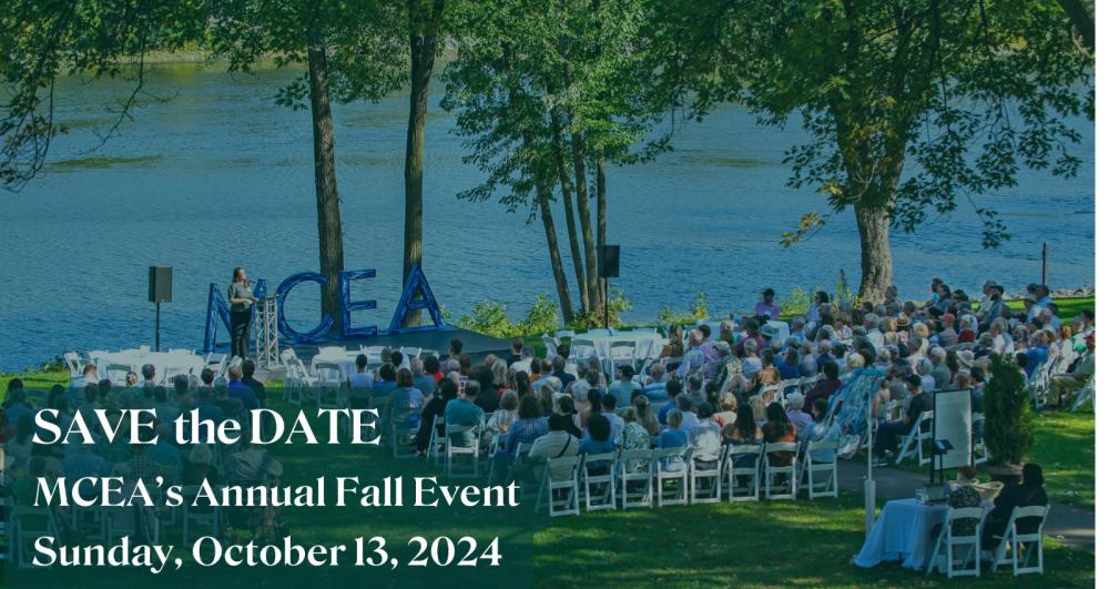 save the date for our fall event with a photo of an audience watching a speaker in front of the river