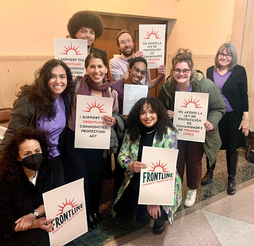 an excited group of people standing holding signs